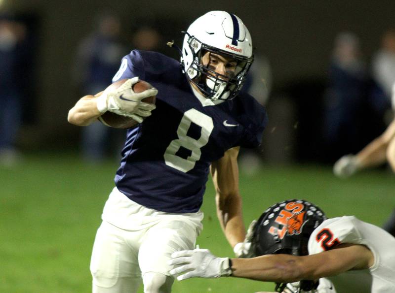 Cary-Grove’s Andrew Prio runs the ball against Libertyville  in first-round Class 6A playoff  football action at Cary Friday.