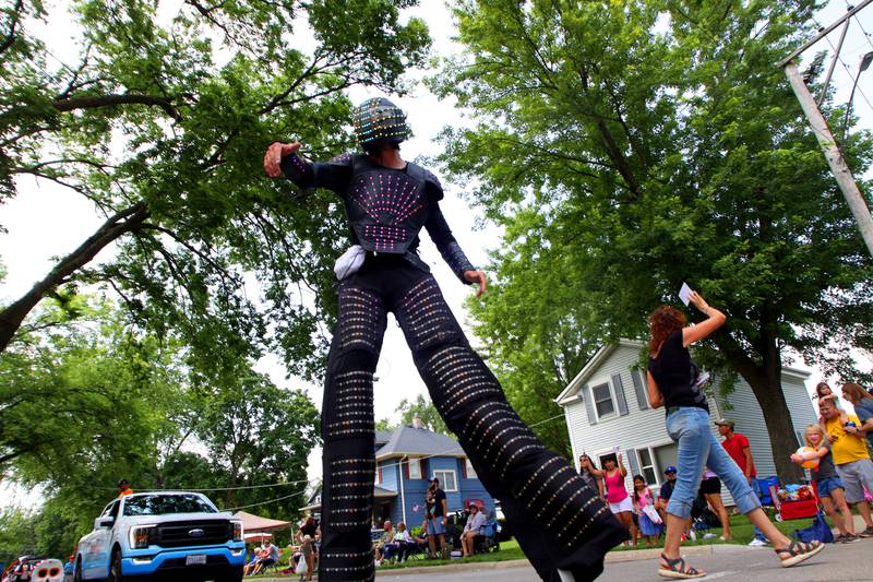 A stilt walker adorned in an LED suit walks in the Fiesta Days parade along Main Street in McHenry Sunday.