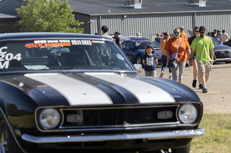 Visitors to Rock Falls’ block party check out the high-performance rides Monday, June 10, 2024. The racers were traveling from speedway to speedway - Byron to Cordova.