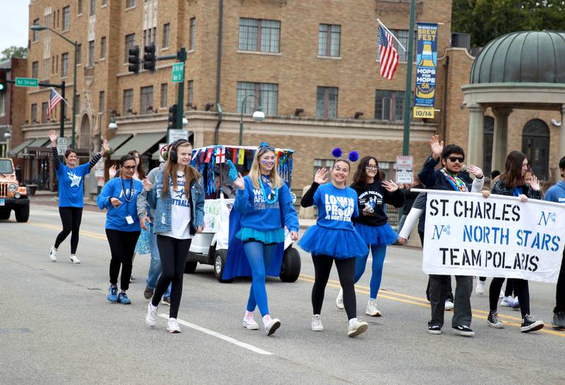 Members of the St. Charles North High School Team Polaris march in the school’s annual homecoming parade on Main Street through downtown St. Charles on Thursday, Oct. 19, 2023.