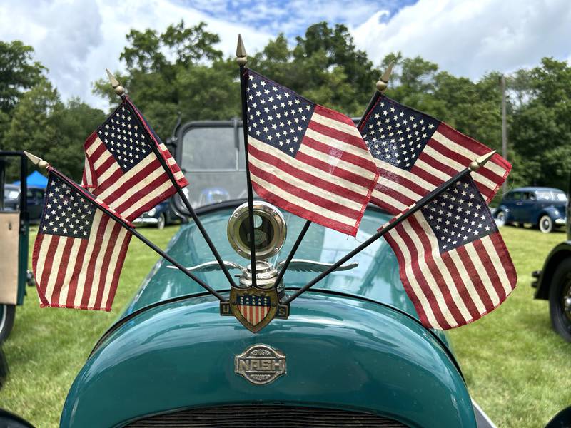 American flags adorn the hood ornament of this 1921 Nash Touring 6, owned by Trevor Carr, of Sharon, Wisconsin, at the Nashional Car Show, held at the Stronghold Camp & Retreat Center on Saturday, June 29, 2024.