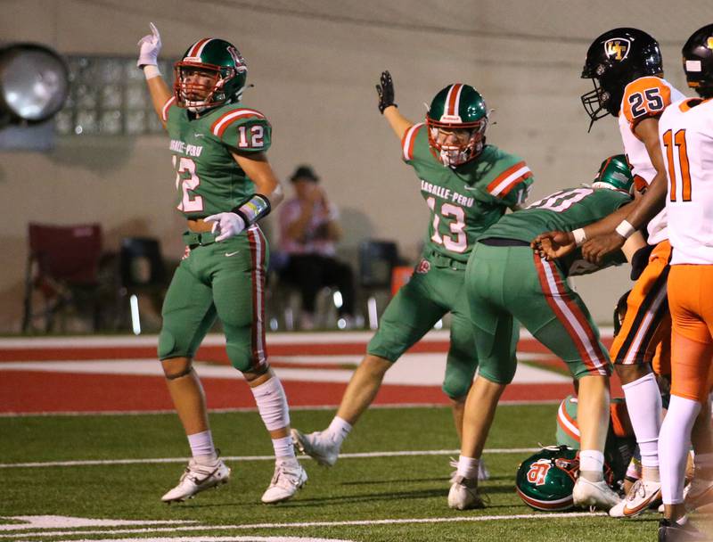 L-P's Rylynd Rynkewicz reacts with teammate Gio Legrenzi after recovering a fumble against United Township on Friday, Aug. 30, 2024 at Howard Fellows Stadium.