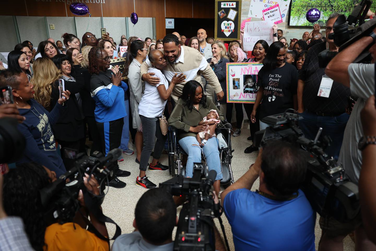 Friends, family and staff celebrate as Cory and Nakeya Haywood leave the hospital with their daughter Nyla during a send off party at Silver Cross Hospital on Monday, May 13, 2024 in New Lenox. Nyla is the youngest preemie, born Nov. 17, 2023, at 22 weeks and 3 days, weighing 1.1 pounds, Silver Cross Hospital’s NICU has cared for.