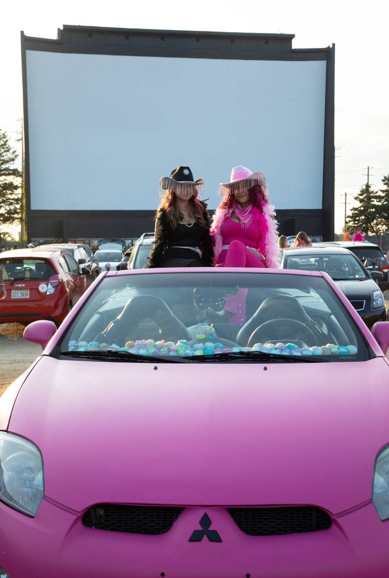 Lacy, right, and Ayla of Ingleside sit in Lacy’s pink car during the "Barbie" movie premiere at the McHenry Outdoor Theater on Friday,  July 21, 2023.  Lacy painted the car to look like the car that Barbie drives.