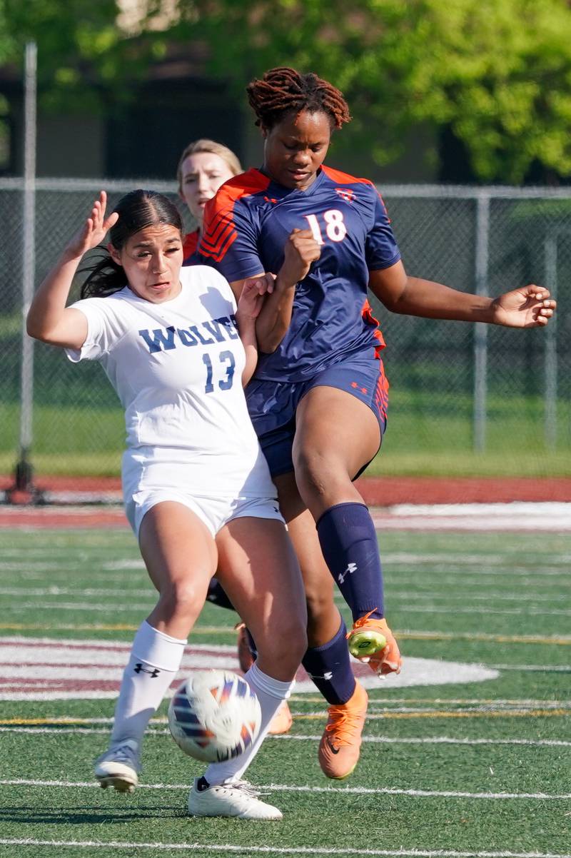 Oswego East's Jocelyn Cruz (13) challenges Oswego’s Jordyn Washington (18) for the ball during a Class 3A Lockport Regional semifinal soccer match at Lockport High School in Lockport on Wednesday, May 15, 2024.