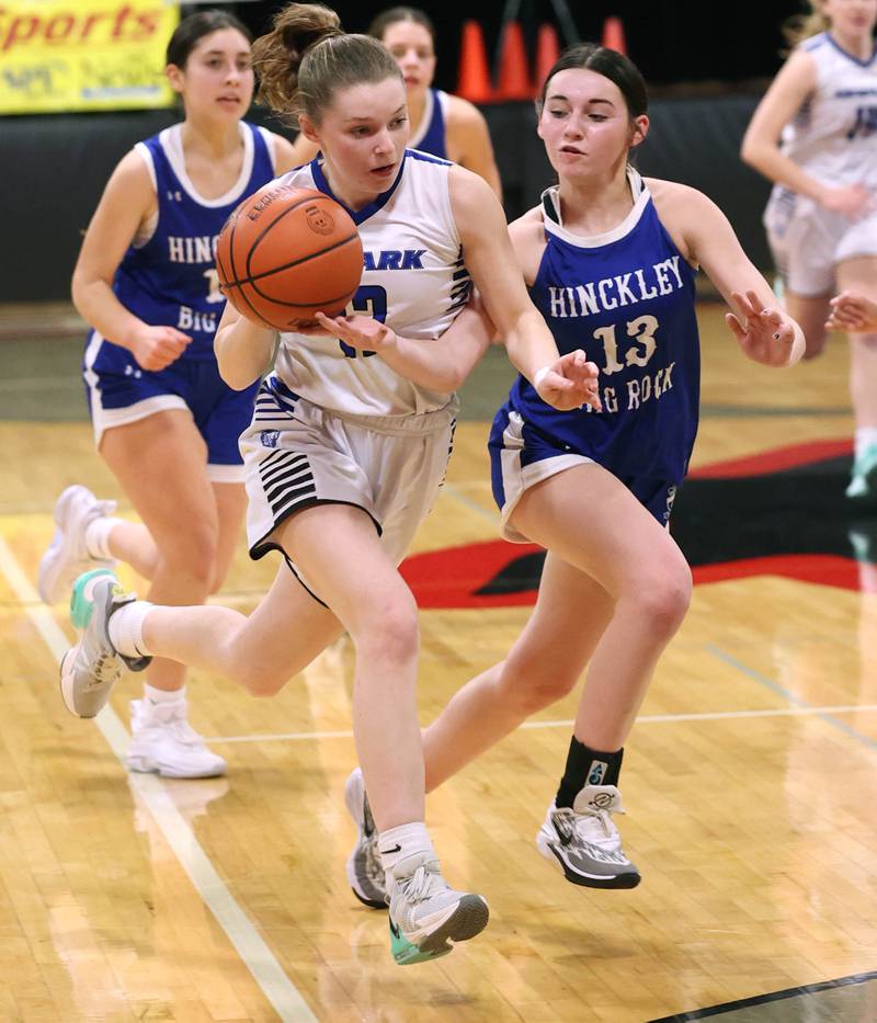 Newark’s Tess Carlson pushes the ball ahead of Hinckley-Big Rock's Mia Cotton Thursday, Jan. 18, 2024, during the Little 10 girls basketball tournament at Indian Creek High School in Shabbona.