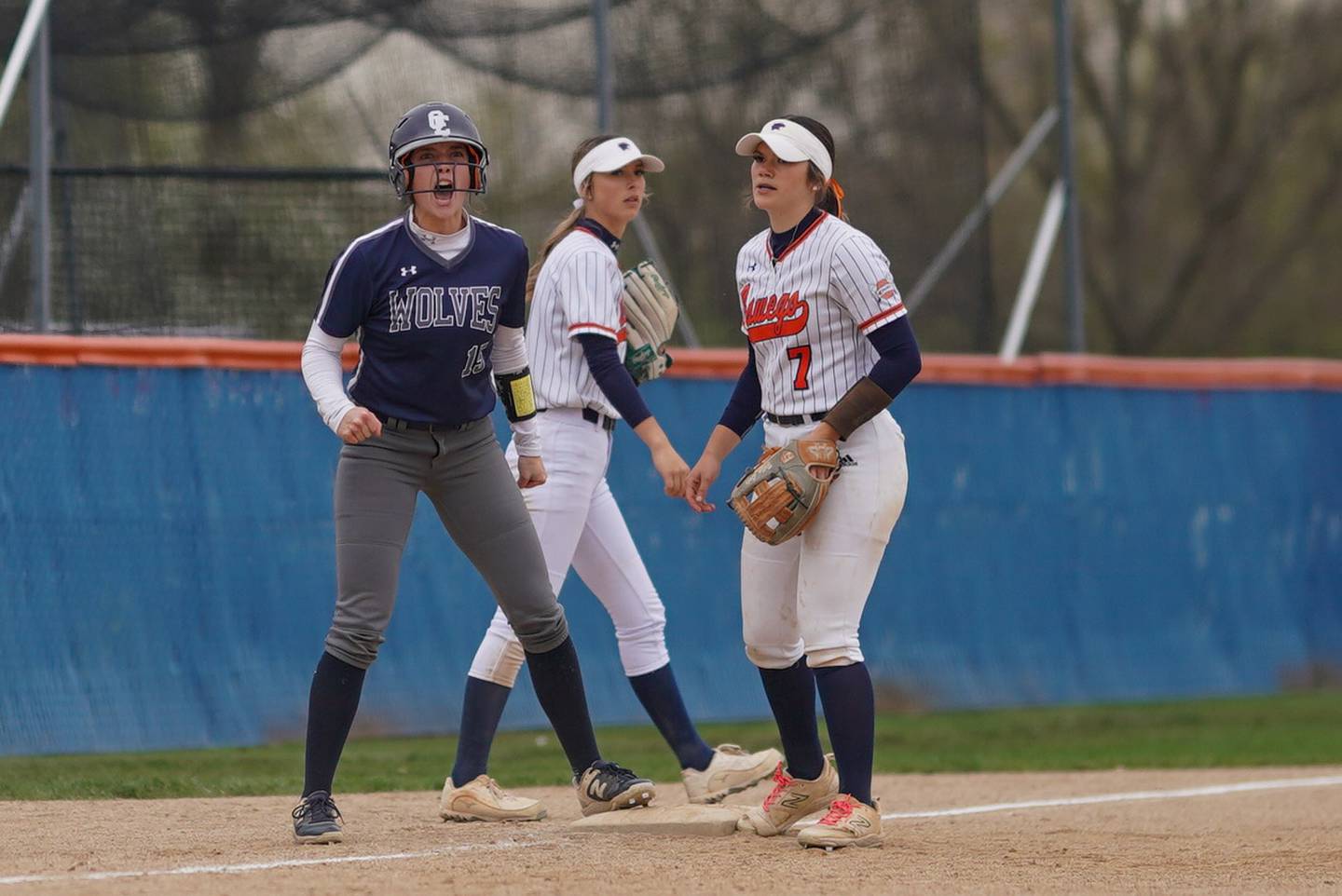 Oswego East's Finley Anderson (15) reacts after hitting a 2 run triple against Oswego during a softball game at Oswego High School on Thursday, April 18, 2024.