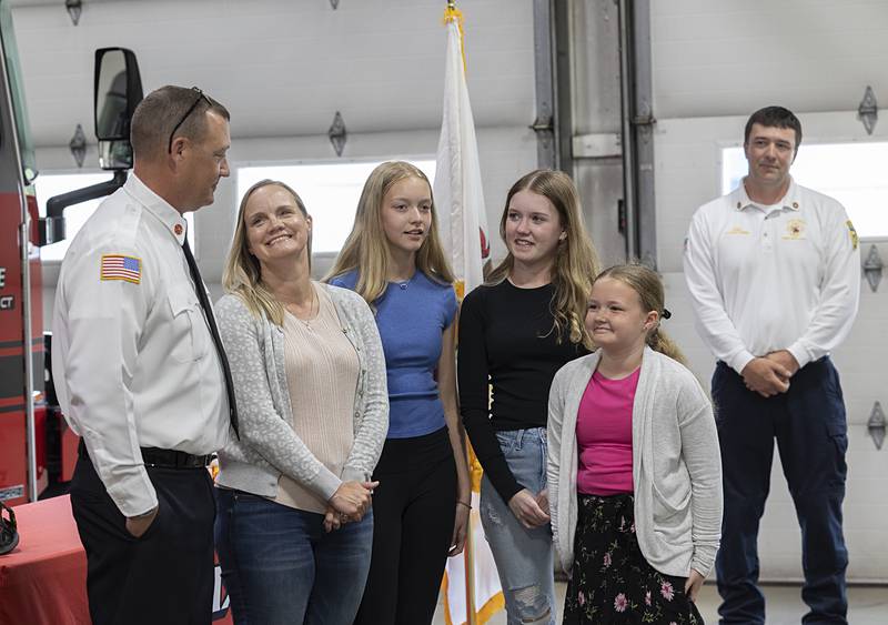 Derrick Storey (left), with wife Jennifer and daughters Natalie, 13, Madison, 15, and Avery, 10, says a few words to colleagues and supporters Tuesday, May 14, 2024 after being sworn in as new assistant fire chief.