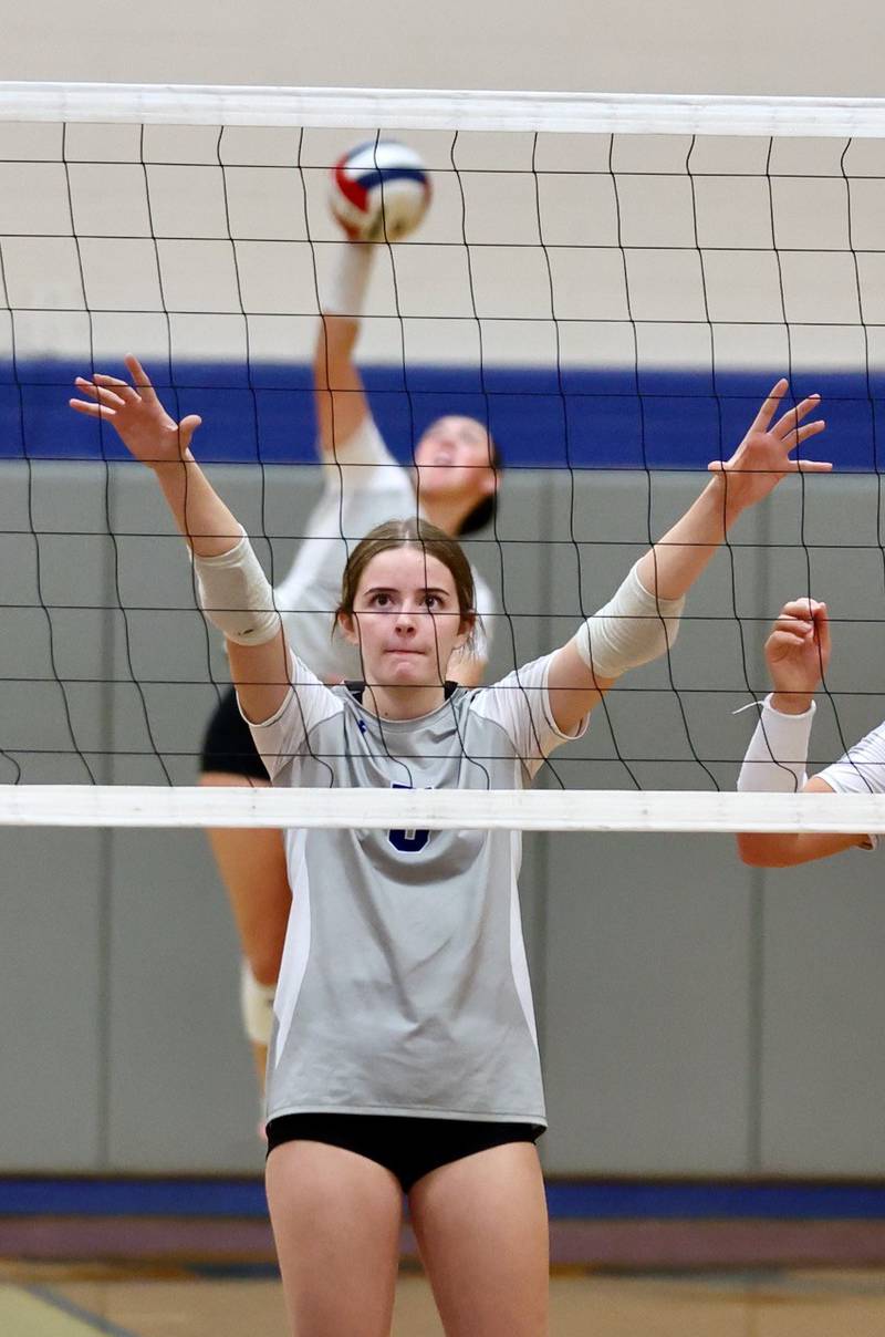 Senior Karsyn Brucker defends the net for Princeton Tuesday night at Prouty Gym.