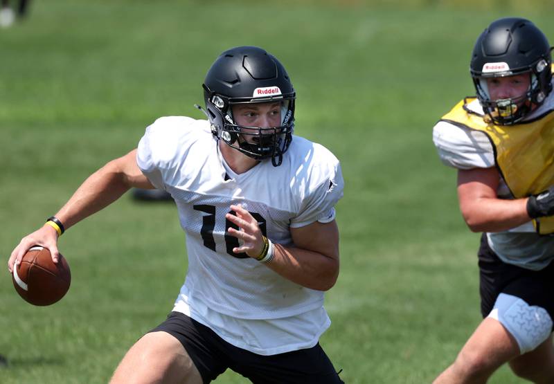 Sycamore quarterback Burke Gautcher scrambles away from pressure Monday, July 15, 2024, during summer football camp at Sycamore High School.