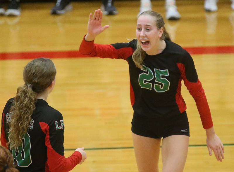 L-P's Addison Urbanski hi-fives teammate Katie Sowers after winning the second set over Geneseo in the Class 3A Regional on Tuesday, Oct. 24, 2023 at Sellett Gymnasium.