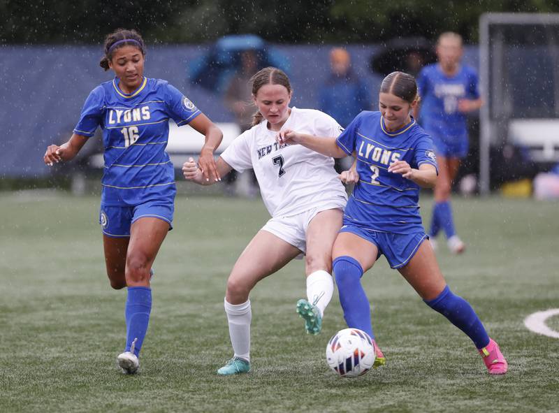 New Trier's Maeve Driscoll (7) fights for the ball against Lyons' Leahla Frazier (16) and Josie Pochocki (2) during the Class 3A Dominican super-sectional between New Trier and Lyons Township in River Forest on Tuesday, May 28, 2024.