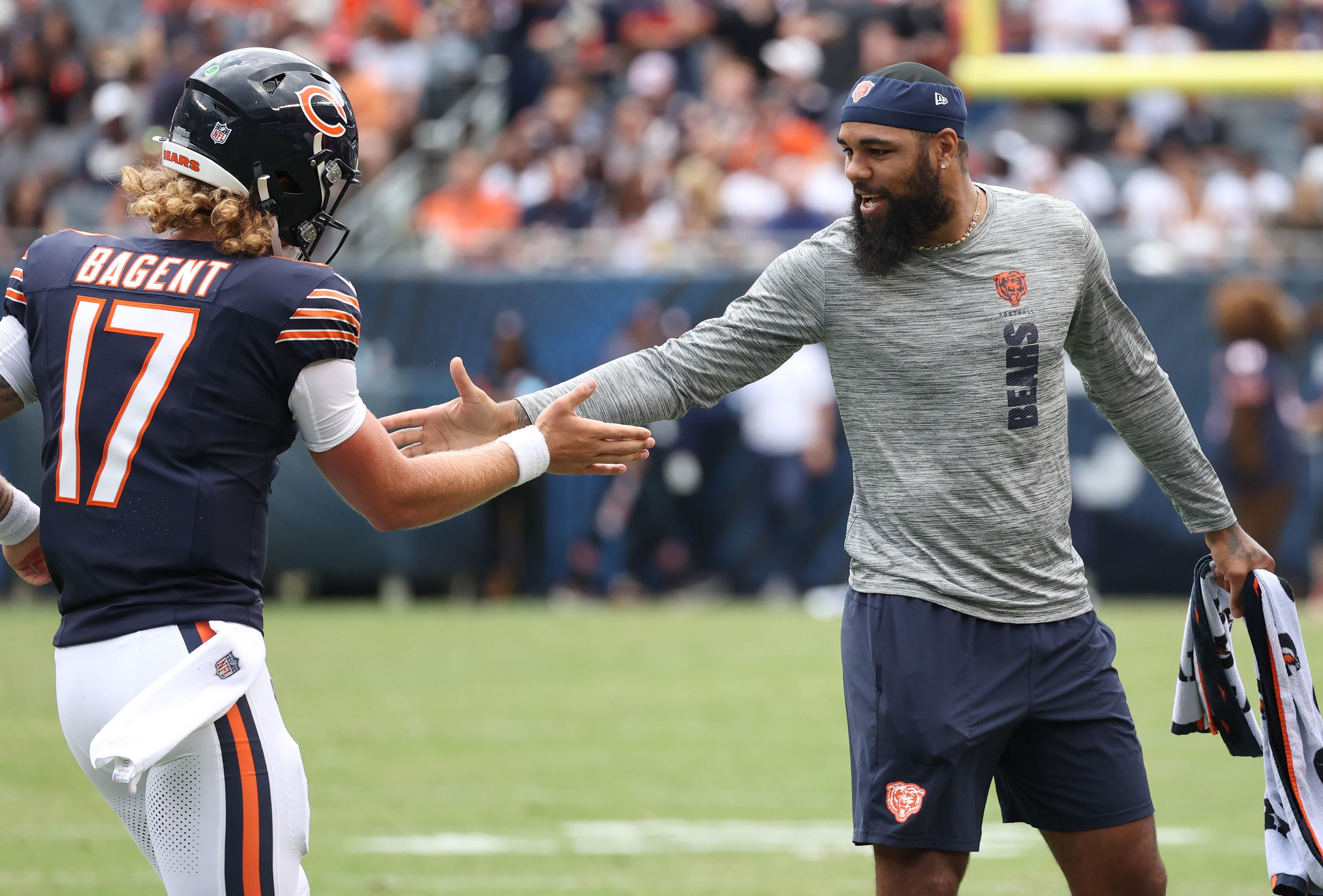 Chicago Bears quarterback Tyson Bagent (left) is congratulated by Chicago Bears wide receiver Keenan Allen after throwing a touchdown pass during their game against the Cincinnati Bengals Saturday, Aug. 17, 2024, at Soldier Field in Chicago.