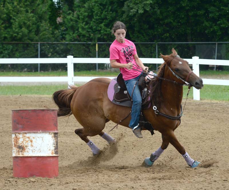 Molly Bettner, 16 of Oregon, steers DJ  in the 18-under barrel racing competition at the WHOA benefit horse show on Saturday, June 22, 2024 at the Whiteside County fairgrounds in Morrison.