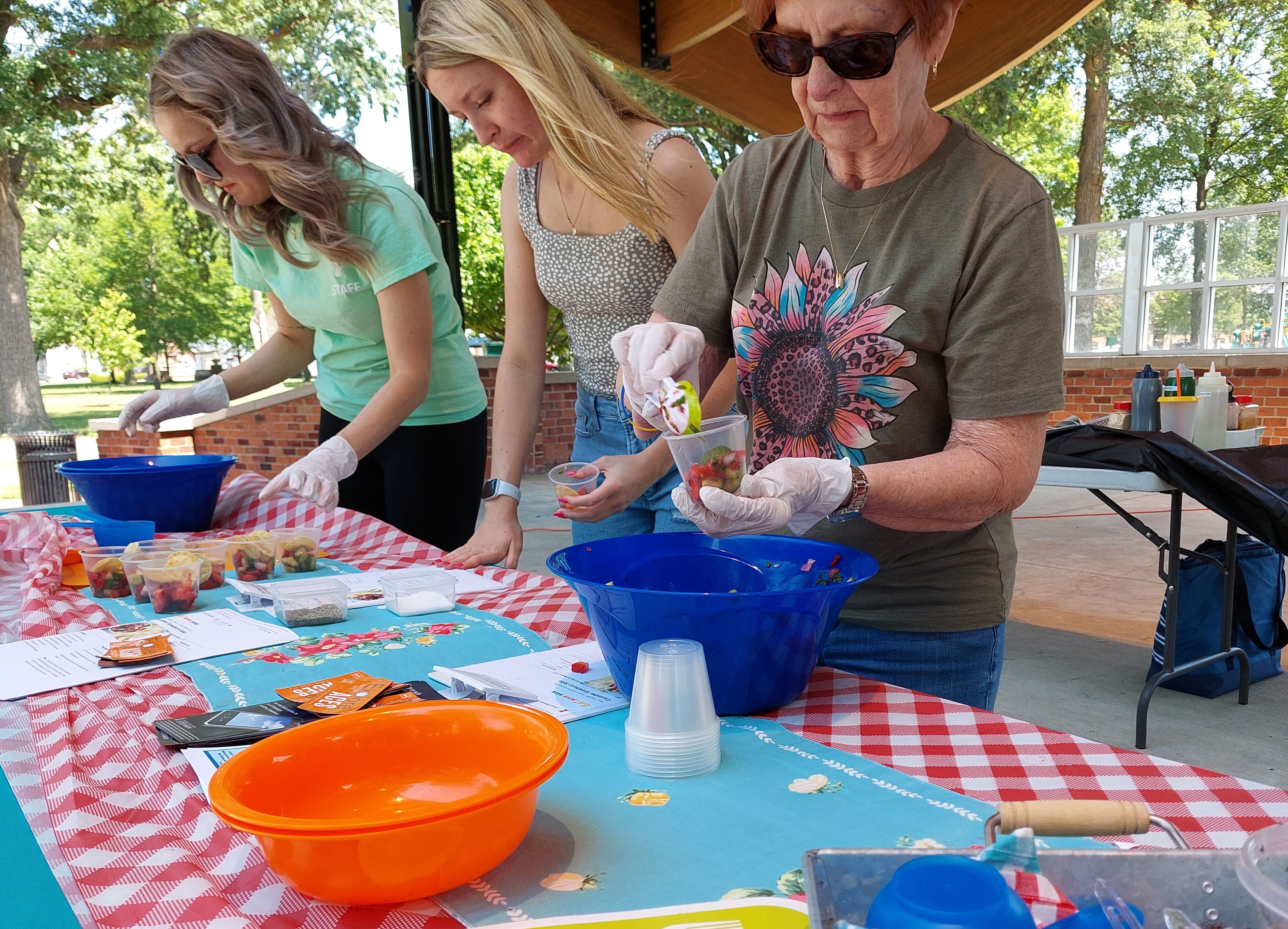 The University of Illinois Extension prepares samples of salsa Saturday, June 10, 2023, during Live Well Streator's Family Health and Fitness Day at City Park.