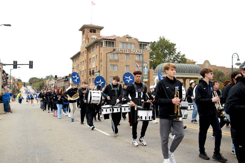 The St. Charles North Marching Band walk in the school’s annual homecoming parade on Main Street through downtown St. Charles on Thursday, Oct. 19, 2023.