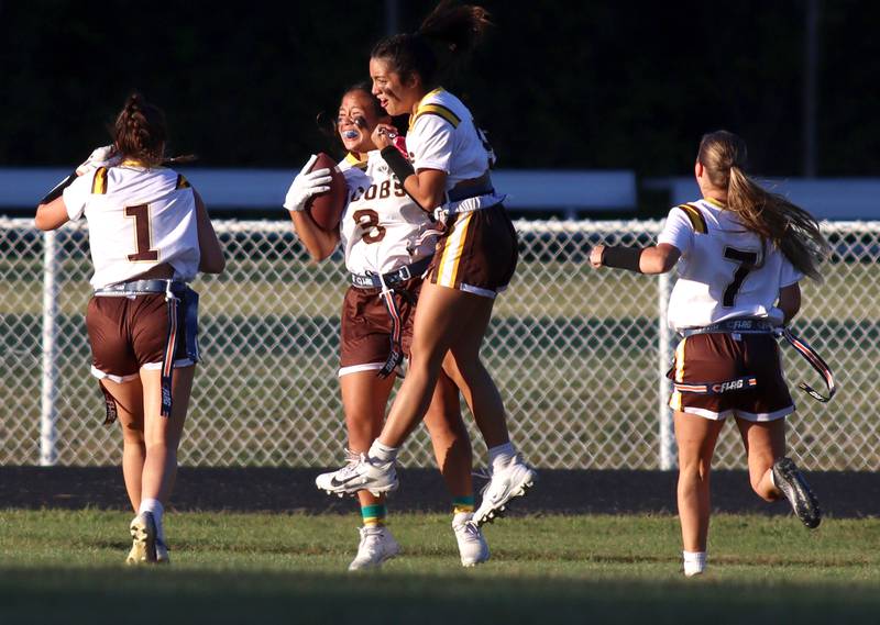 Jacobs’  Sophia Acot is greeted in the end zone after returning an interception for a touchdown in varsity flag football on Tuesday, Sept. 3, 2024, at Dundee-Crown High School in Carpentersville.