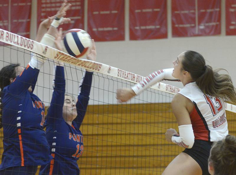 Streator’s Mya Zavada (13, at right) swings at the Pontiac block Wednesday, Sept. 4, 2024, at Pops Dale Gymnasium in Streator.