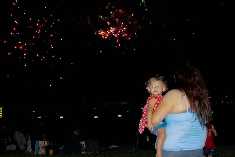 Woman holds baby whilst watching fireworks on Saturday, June 29, 2024 at Lake Mendota.