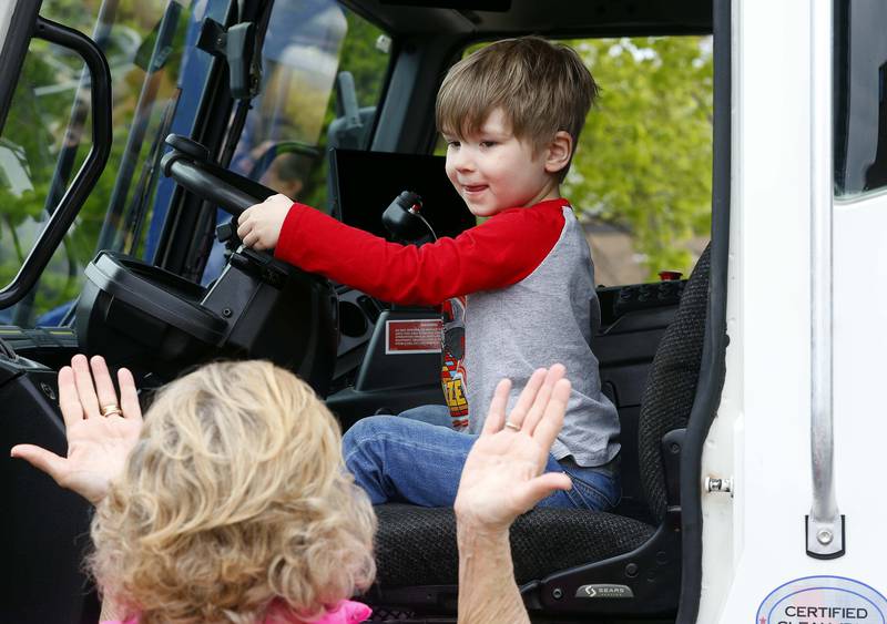 Three-year-old Brett Erb, of Wheaton, sits behind the wheel of a giant garbage truck during the Downtown Wheaton Association’s kid-friendly Touch-a-Truck event Saturday, April 27, 2024 in Wheaton.