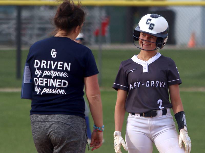 Cary-Grove’s Aubrey Lonergan is all smiles after stealing third base against  Burlington Central in varsity softball at Cary Monday.