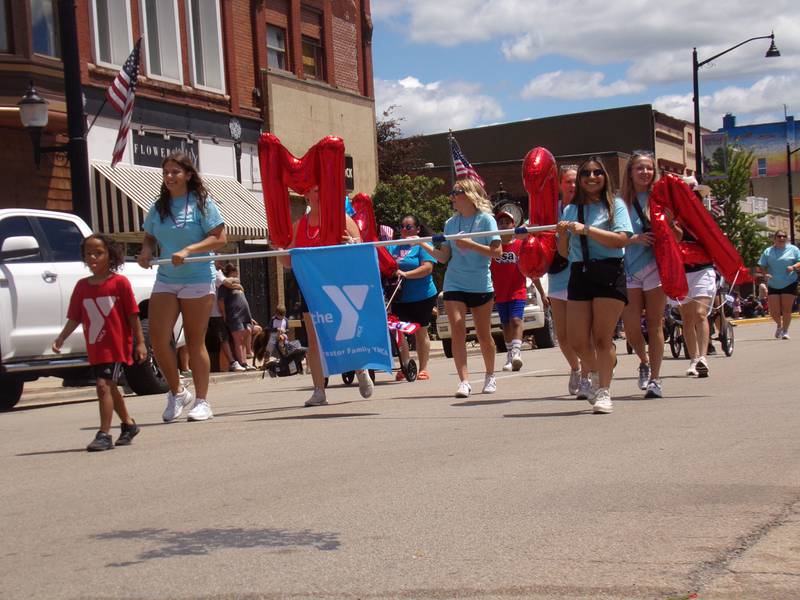 The Streator Family YMCA walks in the Liberty Fest parade on Sunday, June 30, 2024, dancing to the "YMCA" song and holding up inflatable letters.