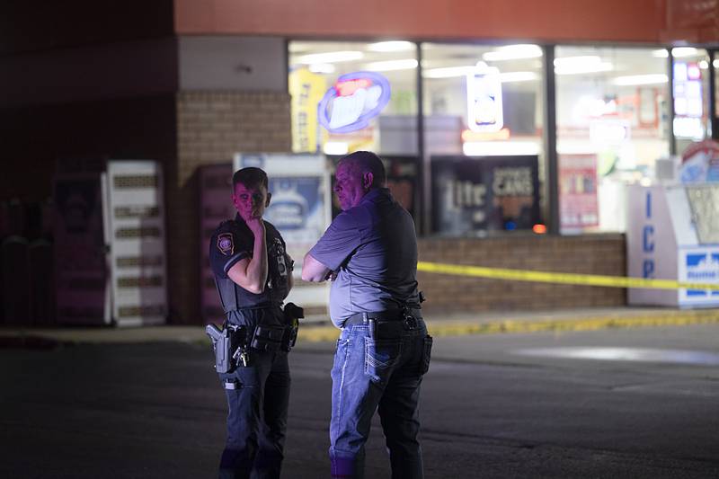 Sterling officer Jamie Russell and Deputy Chief Pat Bartel investigate the scene of a shooting Tuesday, May 28, 2024 at Phillips 66.