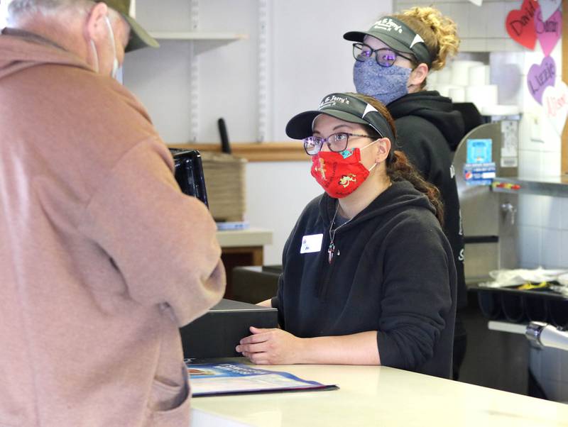 Maria Waterton, a cashier at Tom & Jerry's of Sycamore, takes an order for a customer Wednesday at the restaurant.