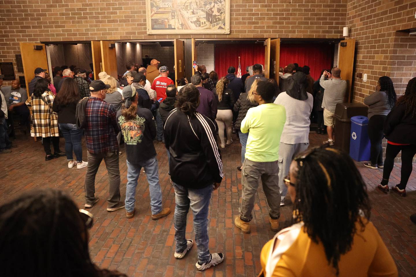 Dozens stands in the foyer of the Billie Limacher Bicentennial Park theater of Joliet Township meeting as residents want answer or the township asylum grant money on Tuesday, Oct. 10, 2023 in Joliet.