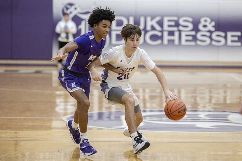 Dixon’s Mason Weigle handles the ball against Rochelle’s Cayden Moore Monday, Dec. 5, 2022.