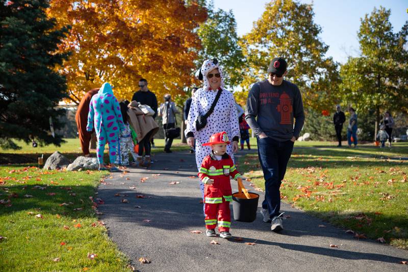 Lisa, left, Justin, right, and Emmett (2) Baker walk along the Trick-or-Treat trail at Boo Bash on Saturday, Oct. 22, 2022.