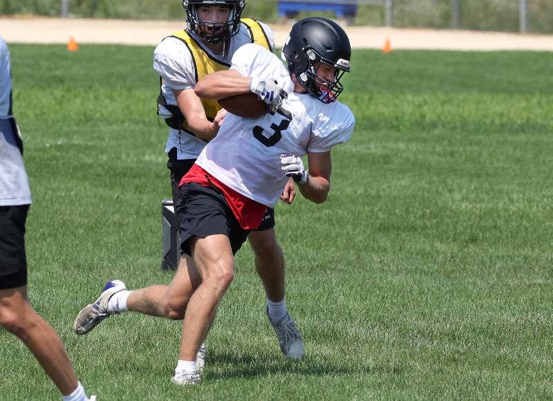 Sycamore’s Carter York runs the ball after a catch Monday, July 15, 2024, during summer football camp at Sycamore High School.