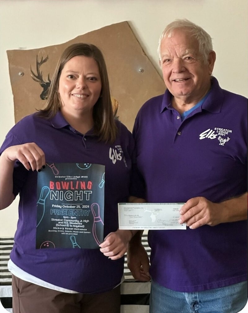 Streator Elks Club Exalted Ruler Ashley Meiners (left) holds a poster and Treasurer Robert "Obie" Oberholtzer holds a grant check in a promotional photo ahead of a free bowling night hosted by the Elks Club on Friday, Oct. 25, for junior high and high school students.