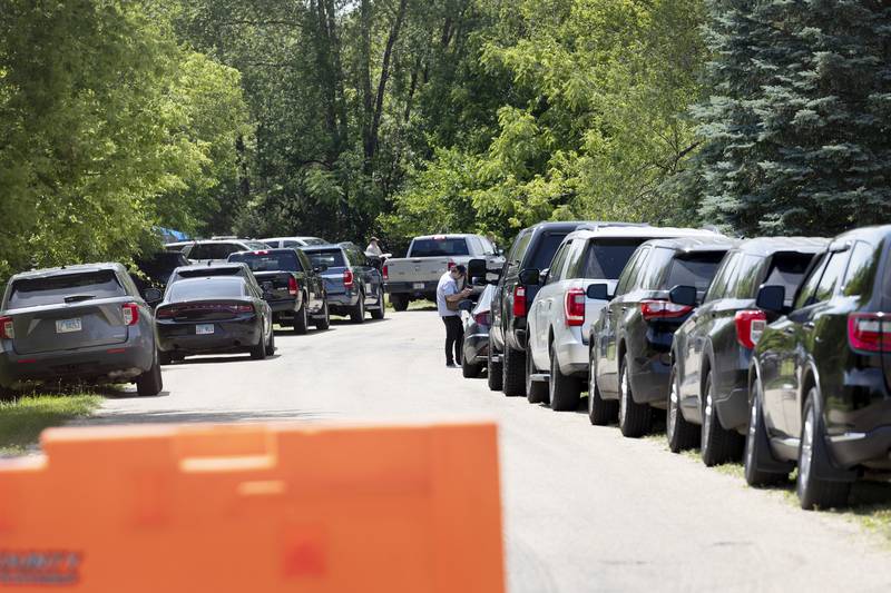 Squad and investigation cars line Wild Rice Lane Wednesday, June 12, 2024 in Lost Lake outside of Dixon.