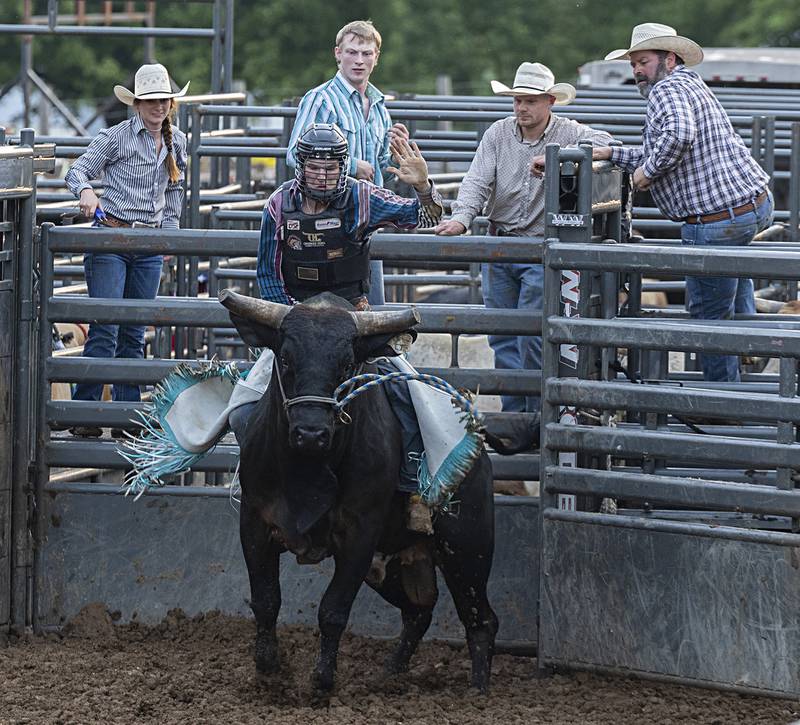 Nick Prater hangs on as “El Chapo” bucks from the chute in the Rice Bull Riding and Barrel Racing event Thursday, August 11, 2023 at the Carroll County fair.