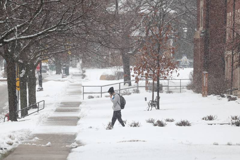 A student leave one of the campus buildings at University of St. Francis as afternoon rain turns to evening snow on Tuesday, Jan. 9, 2024 in Joliet.