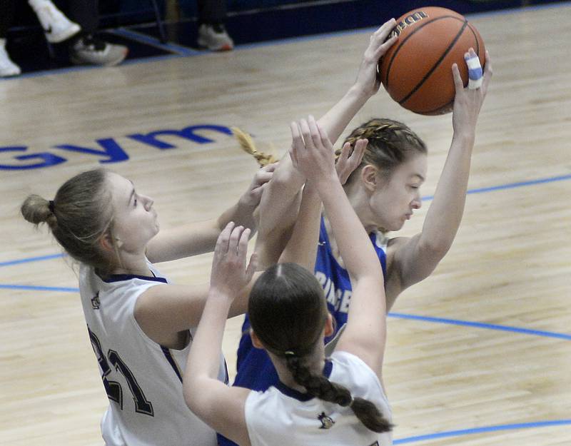 Princeton’s Keighley Davis pulls a rebound away from Marquette’s Avery Durdan and Chloe Larson in Bader Gymnasium on Saturday, Jan. 7, 2023 at Marquette High School.