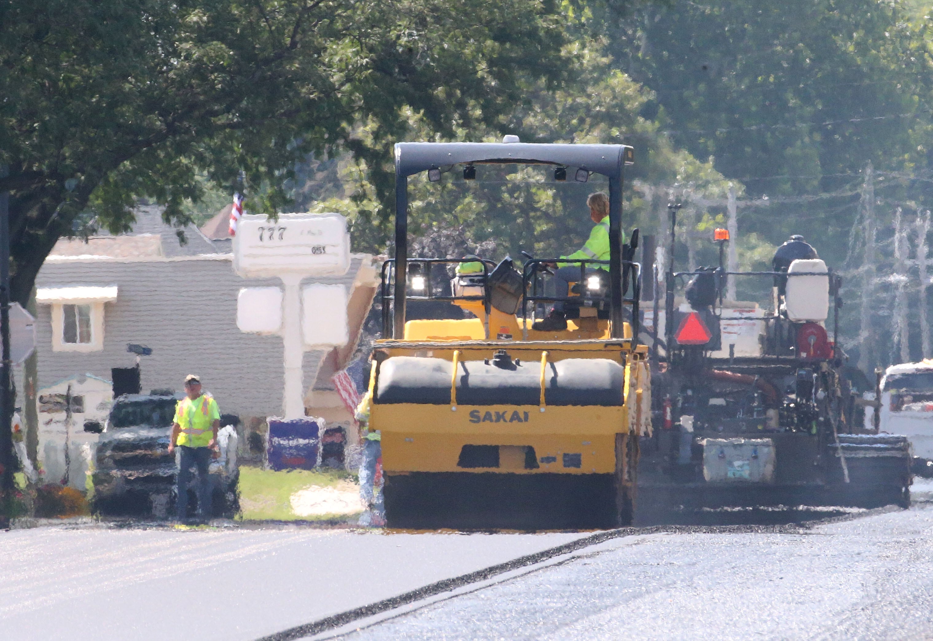 The heat from fresh blacktop can be seen as crews pave South Main Street on Tuesday, Aug. 13, 2024 downtown Princeton.