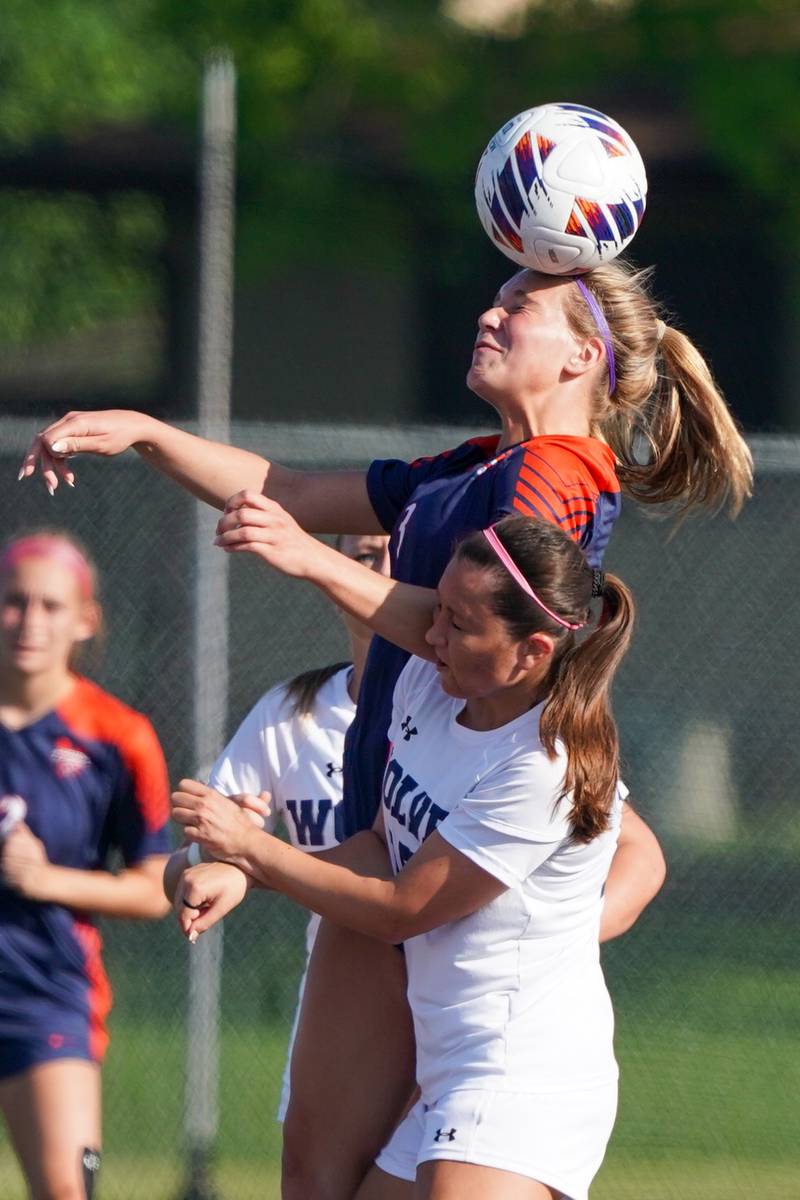 Oswego’s Gillian Young (3) goes up for a header over Oswego East's Lana Bomstad (15) during a Class 3A Lockport Regional semifinal soccer match at Lockport High School in Lockport on Wednesday, May 15, 2024.