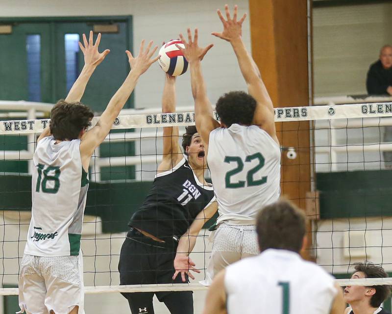 Downers Grove North's Aidan Akkawi (11) spikes the ball during volleyball match between Downers Grove North at Glenbard West.  April 2, 2024.