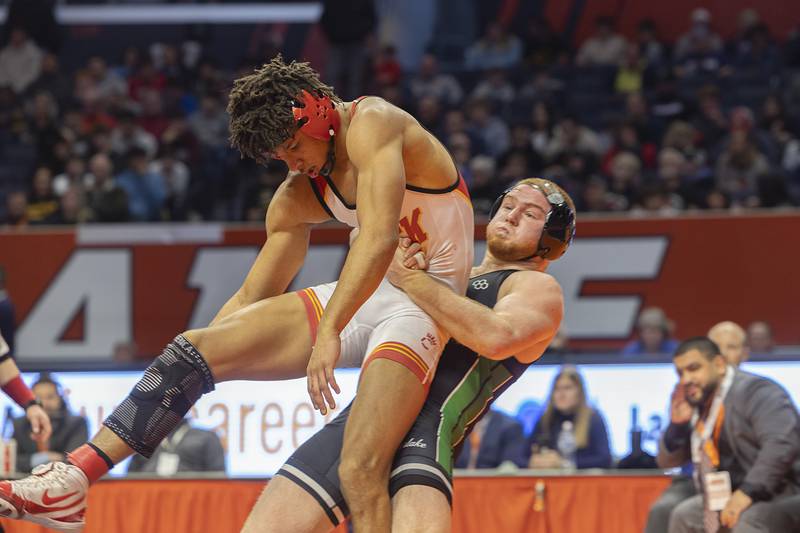 Grays Lake Central’s Matty Jens throws Rock Island’s Amare Overton in the 2A 175 pound championship match Saturday, Feb. 17, 2024 at the IHSA state wrestling finals at the State Farm Center in Champaign.