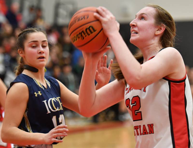 Timothy Christian's Grace Roland (right) starts to shoot while guarded by IC Catholic's Analisa Raffaelli during the Class 2A Timothy Christian Regional championship game on Feb. 17, 2023 at Timothy Christian High School in Elmhurst.