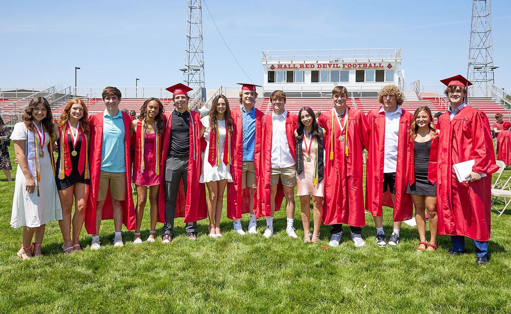 Hall High School graduates Lili Heredia, Jennifer Casford, Ethan McInnes, Jayden Jones, Hunter Meagher, Clara Jablonski, Riley Coble, Ashton Pecher, Abby Kaszynski, Grant Plym, Mac Resetich, Ella Taliani, Josh Scheri pose for a photo after the graduation ceremony on Sunday, May 21, 2023, outdoors at the high school.