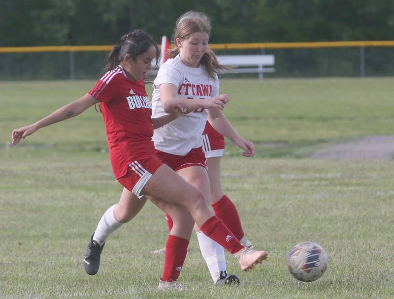 Streator's Ophelia Orozco (left) kicks the balll away from Ottawa's Sophia Falaney during the Class 2A La Salle-Peru Regional quarterfinal Friday, May 10, 2024, at James Street Recreation Area in Streator.