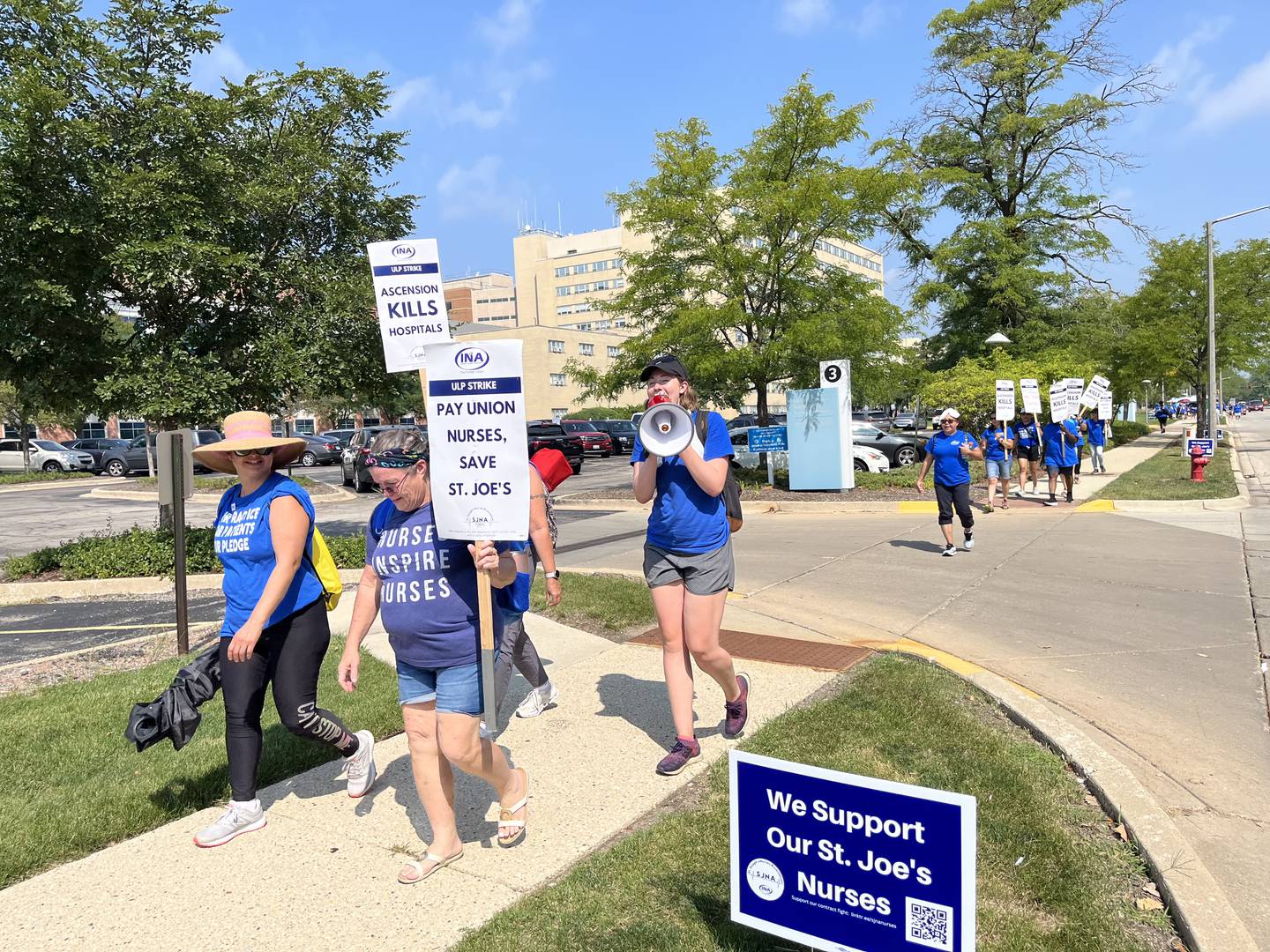 Sarah Hurd, an organizer with Illinois Nurses Association, holds a megaphone while marching with union nurses during their strike on Wednesday, Aug. 23, 2023, outside Ascension Saint Joseph – Joliet.