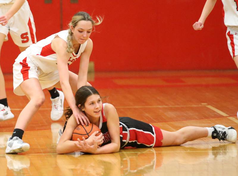 Henry-Senachwine's Kaitlyn Anderson (bottom) falls on top of a loose ball as Streator's Cailey Gwaltney (top) tries to knock it free on Wednesday, Jan,. 4, 2023 at Streator High School.