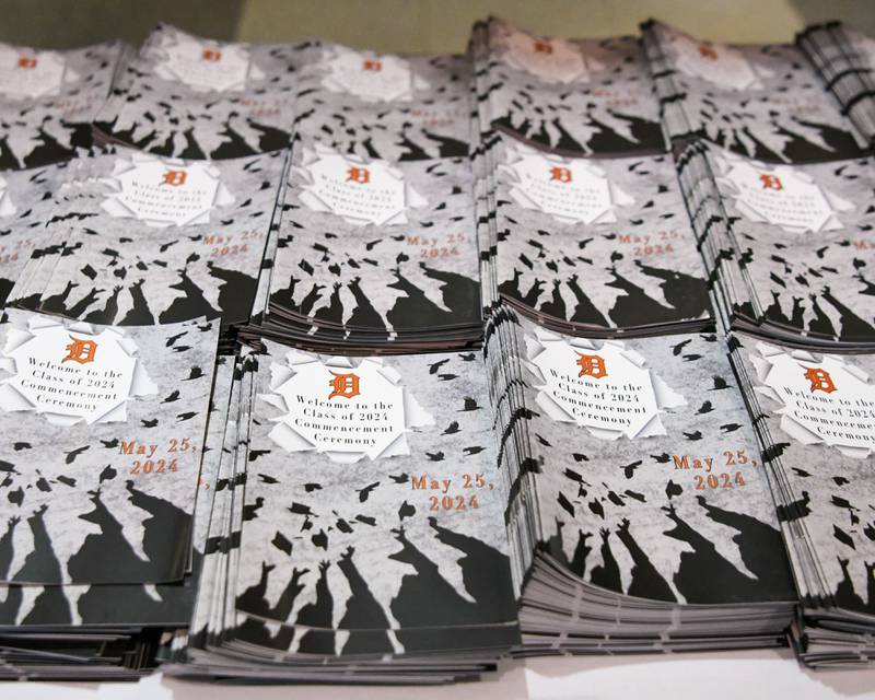 Graduation programs ready to be handed out before the start of the 2024 DeKalb High School commencement ceremony on Saturday, May 25, 2024, at the Northern Illinois University Convocation Center in DeKalb.