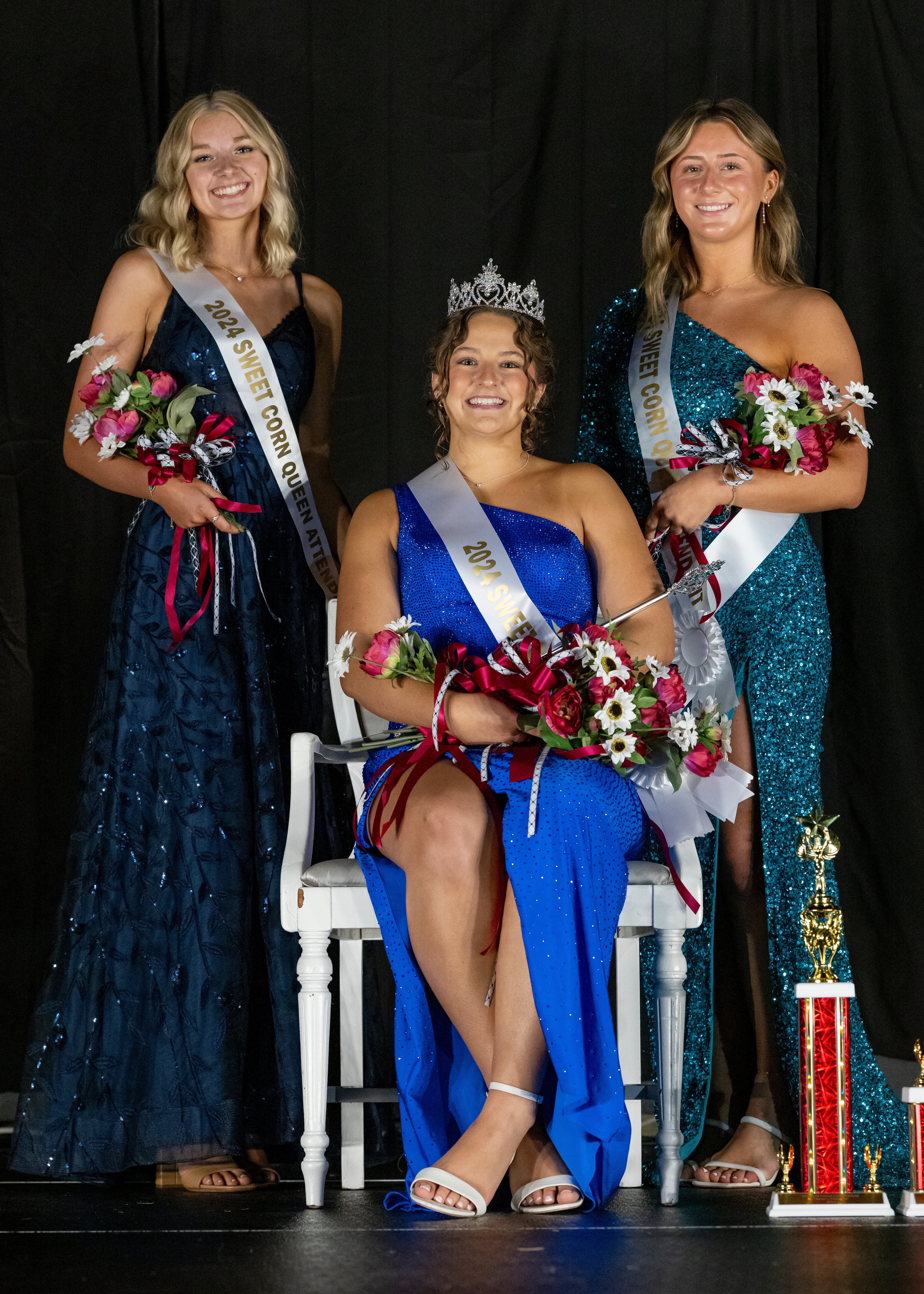 The 2024 Mendota Sweet Corn Festival 
 Queen Madelyn Becker (center) and attendants Bria Frey (left) and Ava Jones (right) pose for a photo after the pageant in Mendota on August 9, 2024.