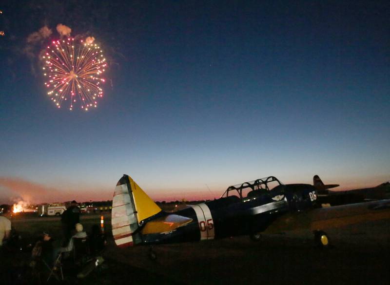 Fireworks emit over a plane during the annual TBM Avenger Reunion and Air Show on Friday, May 17, 2024 at the Illinois Valley Regional Airport in Peru.