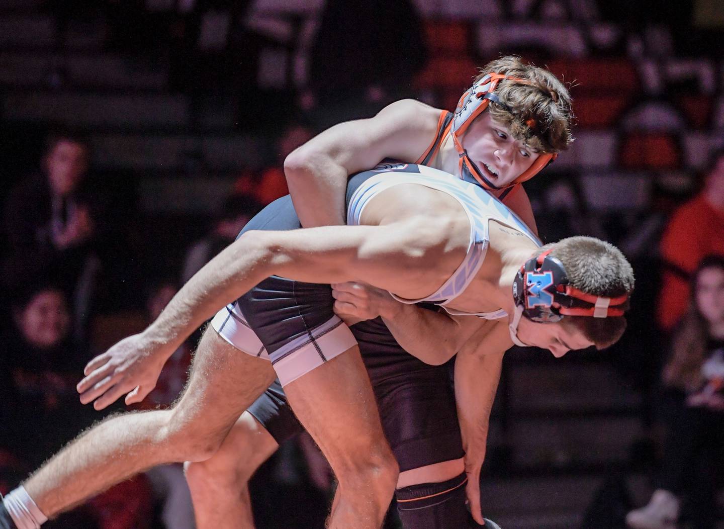 St. Charles East’s Ben Davino and Marian Central’s Vance Williams wrestle at 138 pounds during a match in St. Charles on Wednesday, December 20, 2023.